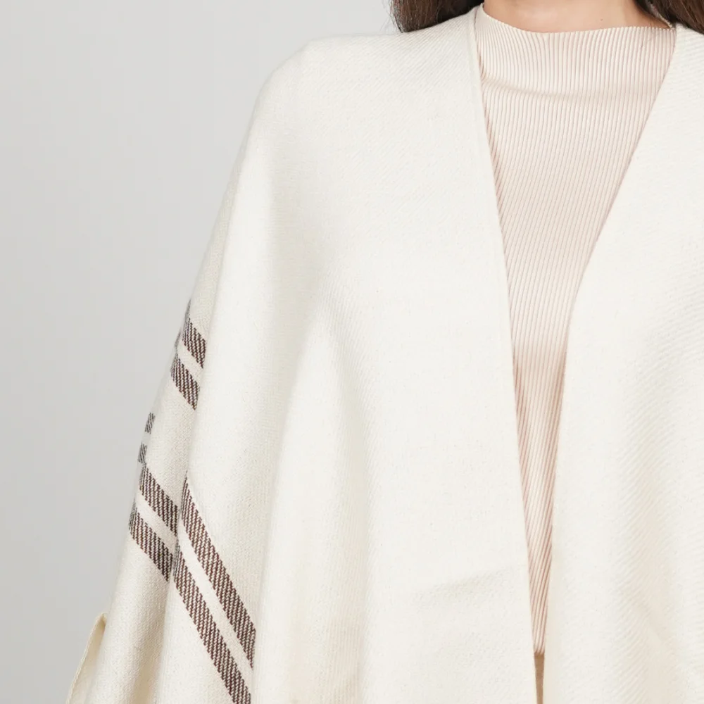 close-up picture of a white alpaca poncho details