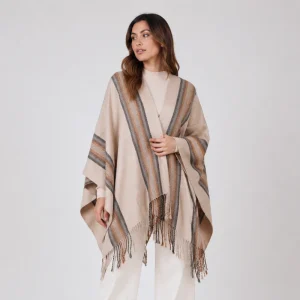 woman wearing alpaca poncho in brown and lines handmade