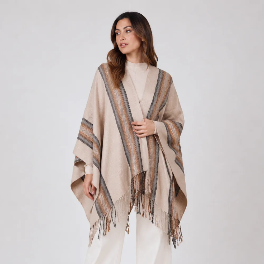 woman wearing alpaca poncho in brown and lines handmade