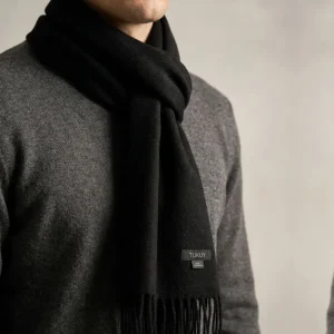 Baby alpaca scarf in black worn by a man with a grey sweater