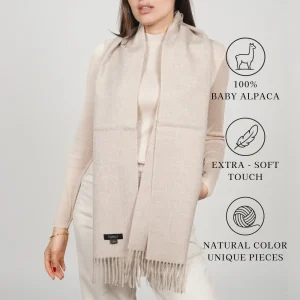 Natural-colored alpaca scarf on a model, labeled 100% baby alpaca, extra-soft touch, natural color unique pieces