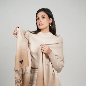 Baby alpaca shawl in gradient brown wrapped around the shoulders with an elegant drape