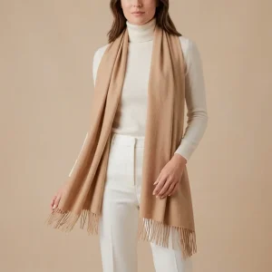 Baby alpaca shawl in beige worn with a white turtleneck sweater
