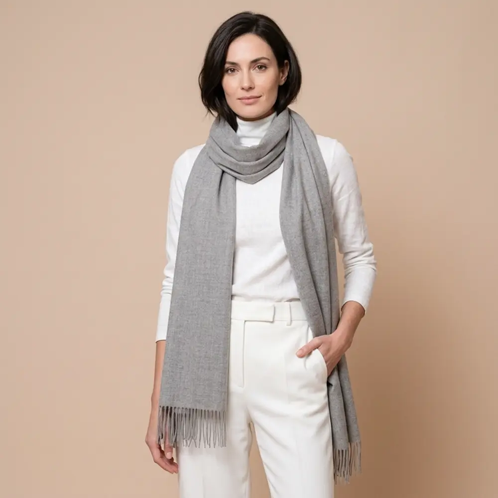 Baby alpaca shawl in grey worn with a white sweater