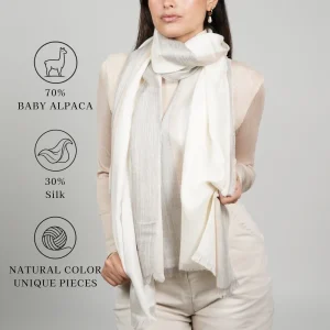 Model wearing a white-color alpaca shawl made of 70% baby alpaca and 30% silk; natural color, unique pieces