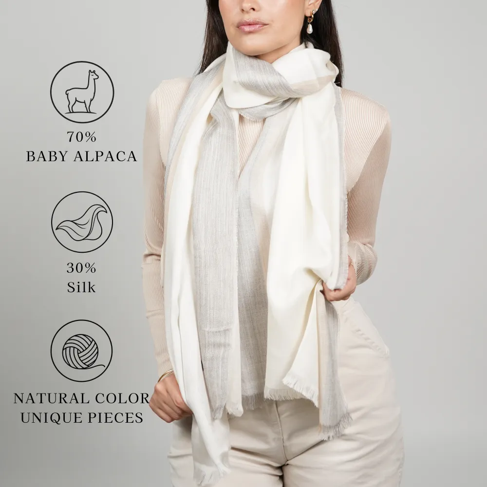 Model wearing a white-color alpaca shawl made of 70% baby alpaca and 30% silk; natural color, unique pieces