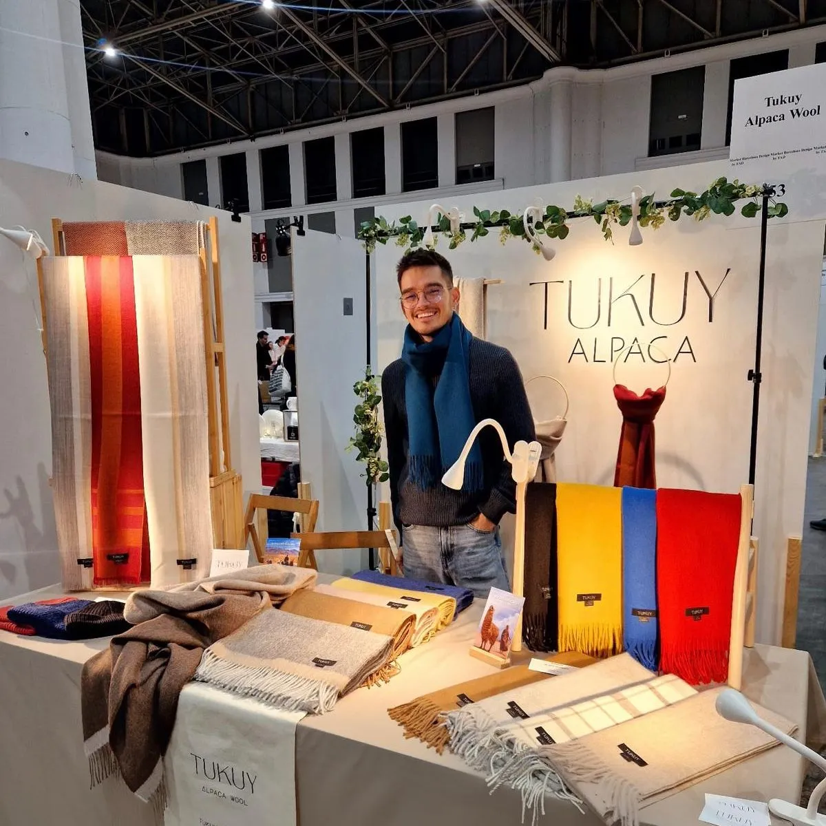 Juan from Tukuy Alpaca in a market, the founder of the brand