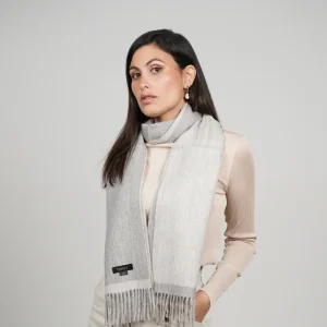Reversible gray alpaca wool scarf worn with neutral clothing, featuring natural gray tones, exceptional softness, and timeless styling.
